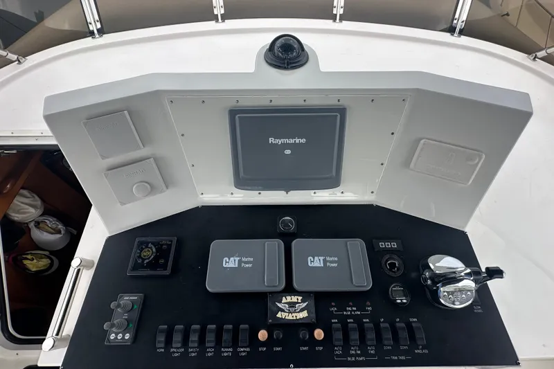 Slide: The Image of Boat control panel with Raymarine display, CAT Marine Power controls, and various switches, Symbol 56, 2003. - 9