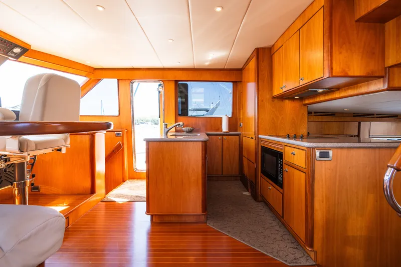 Slide: The Image of Luxurious 2003 Symbol 56 yacht interior with wooden cabinetry and modern amenities. - 57