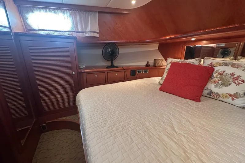 Slide: The Image of Luxurious cabin interior of a 2003 Symbol 56 yacht with elegant wood finishes. - 56