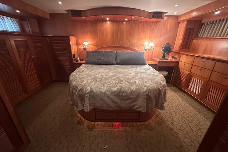 Slide: The Image of Luxurious wooden cabin interior with a cozy bed, ambient lighting, and elegant furnishings on a 2003 Symbol 56. - 43