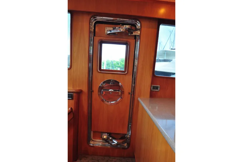 Slide: The Image of Wooden yacht interior with chrome-accented door, Symbol 56, 2003 model. - 18