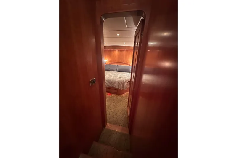 Slide: The Image of Luxurious cabin interior of 2003 Symbol 56 yacht with wooden finish and cozy bed. - 52