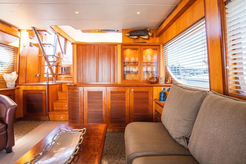 Slide: The Image of Luxurious yacht interior with wooden cabinetry, plush seating, and elegant decor, Symbol 56, 2003 model. - 53