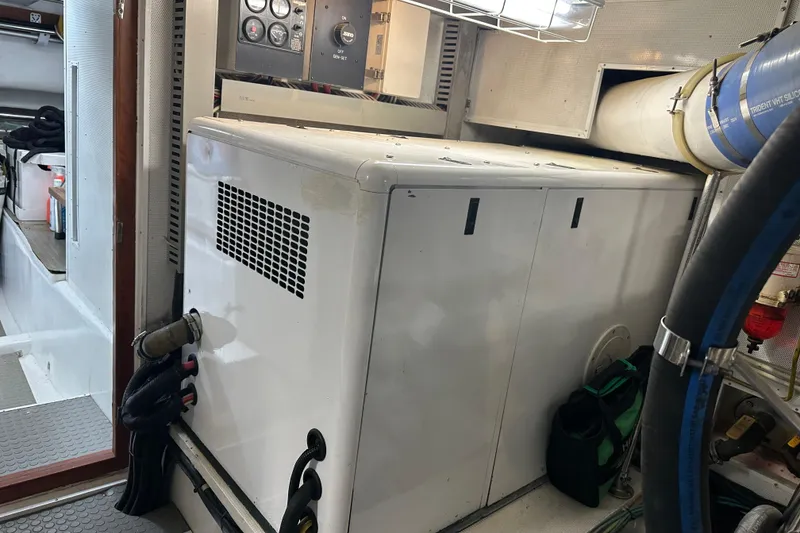 Slide: The Image of Engine room with Symbol 56 generator, control panel, and ventilation system, 2003 model. - 69