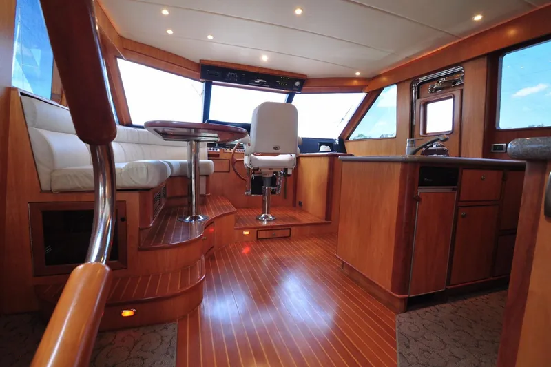 Slide: The Image of Luxurious yacht interior with wooden flooring, seating, and helm station, Symbol 56 model, 2003. - 11
