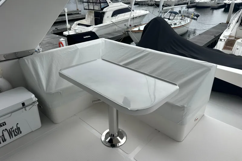 Slide: The Image of Covered seating area on a 2003 Symbol 56 yacht, docked at a marina. - 15