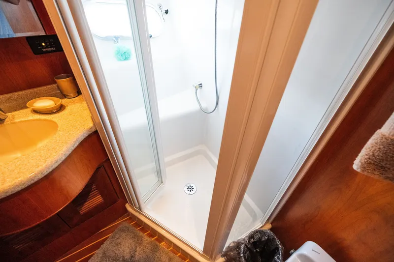 Slide: The Image of Compact bathroom with shower, sink, and wooden cabinetry in a 2003 Symbol 56 model. - 92