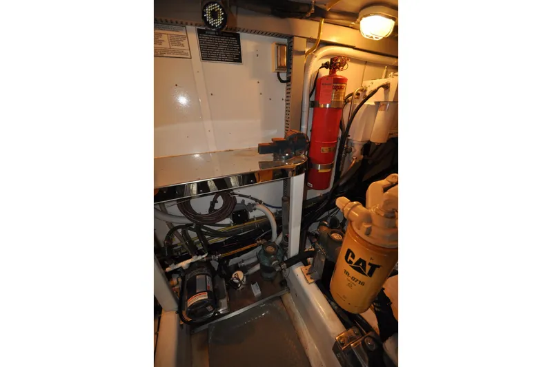 Slide: The Image of Engine room of a 2003 Symbol 56 yacht with CAT filter and fire extinguisher. - 33