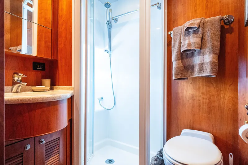 Slide: The Image of Compact yacht bathroom with shower, wooden cabinetry, and modern fixtures, Symbol 56, 2003 model. - 90