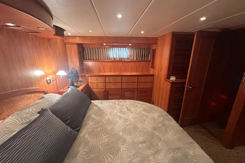 Slide: The Image of Luxurious wooden cabin interior on a 2003 Symbol 56 yacht, featuring cozy bedding and ambient lighting. - 45
