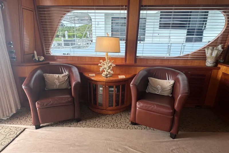 Slide: The Image of Luxurious yacht interior with leather chairs, decorative pillows, and a lamp on a wooden table. - 22