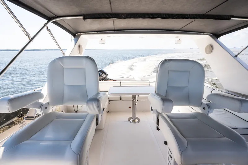Slide: The Image of Luxurious 2003 Symbol 56 yacht interior with plush seating, cruising on open water. - 32