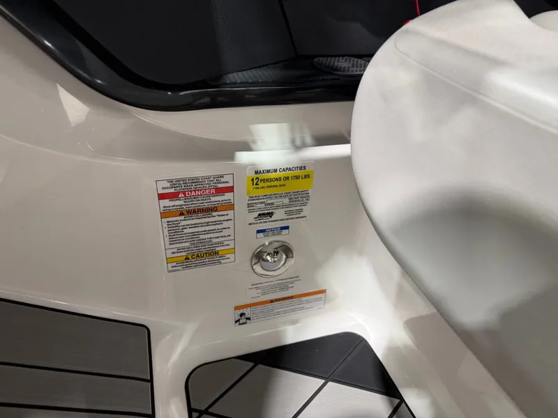 Slide: The Image of Close-up of a boat area with warning labels and capacity information. - 31