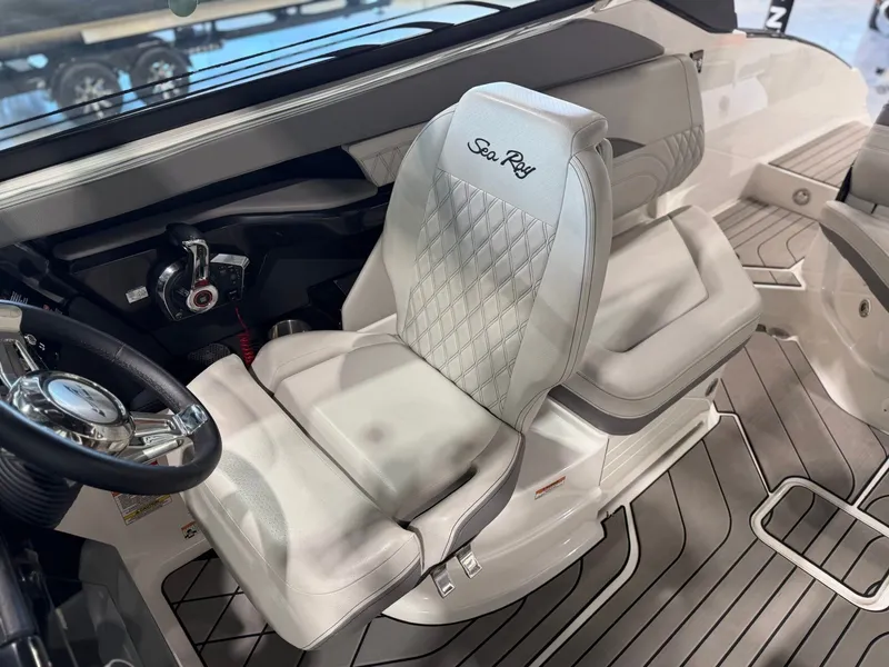 Slide: The Image of Interior of a 2024 Sea Ray SLX 260 Surf with sleek seating and a modern steering wheel. - 26