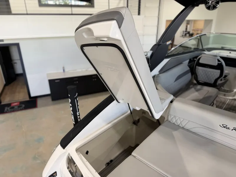 Slide: The Image of The image shows the open storage compartment of a Sea Ray SLX 260 Surf boat. - 14