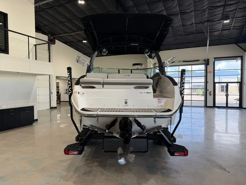 Slide: The Image of The image shows a 2024 Sea Ray SLX 260 Surf boat in a showroom. - 4