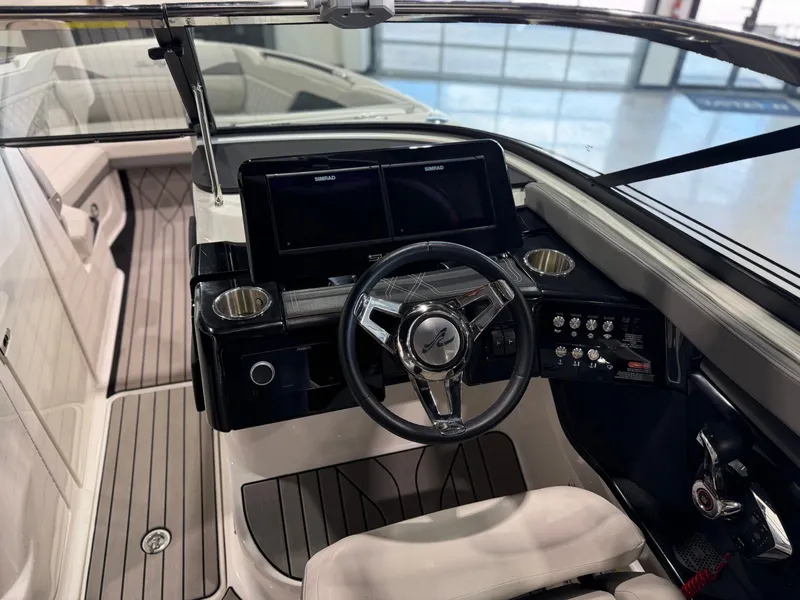 Slide: The Image of The image shows the cockpit of a 2024 Sea Ray SLX 260 Surf boat with a modern helm. - 22