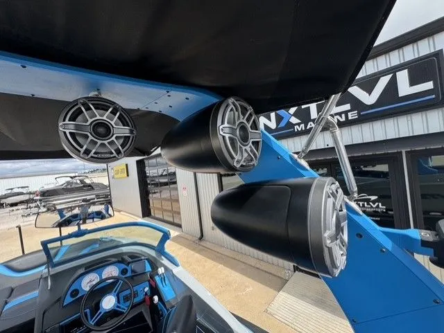Slide: The Image of The image shows the interior of an MB SPORTS B52 23 Alpha boat with speakers and a helm. - 18