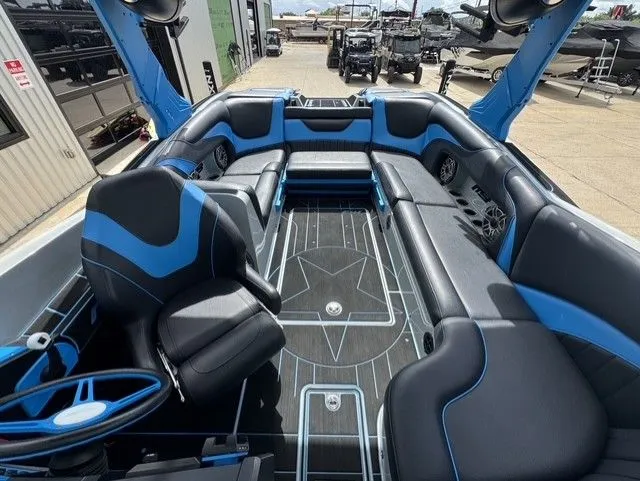 Slide: The Image of Interior of an MB SPORTS B52 23 Alpha boat with blue and black seating. - 19