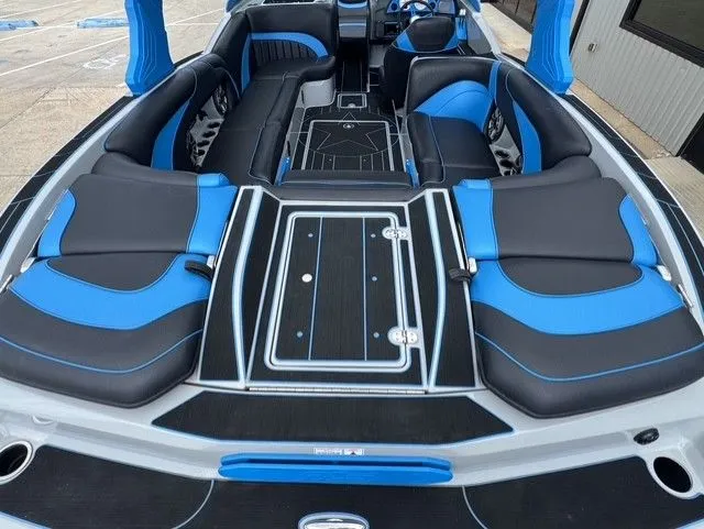 Slide: The Image of Interior view of an MB SPORTS B52 23 Alpha boat with blue and black seating. - 10