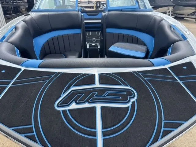 Slide: The Image of The image shows the interior of an MB SPORTS B52 23 Alpha boat with blue and black seating. - 8