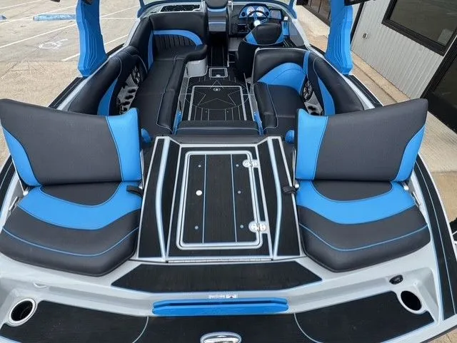 Slide: The Image of Interior of an MB SPORTS B52 23 Alpha boat with blue and black seating. - 11