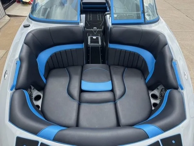 Slide: The Image of The image shows the interior of a 2023 MB SPORTS B52 23 Alpha boat with blue and black seating. - 9