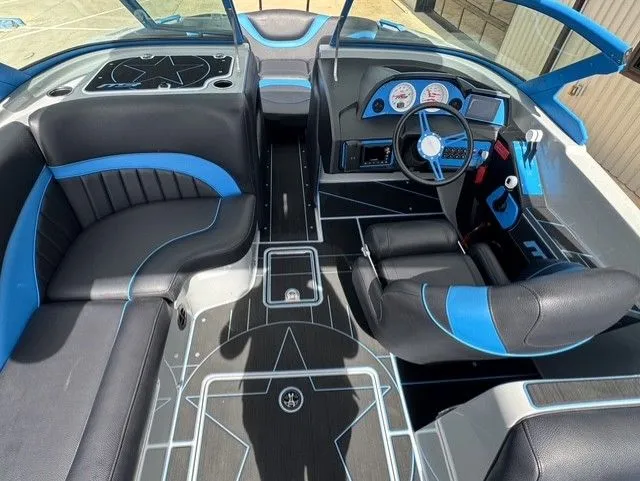 Slide: The Image of Interior of an MB SPORTS B52 23 Alpha boat with blue and black seating. - 15