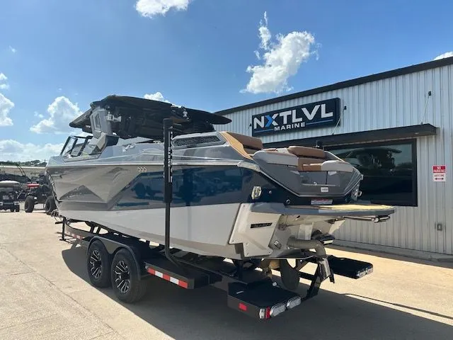 Slide: The Image of A 2025 Super Air Nautique G25 Paragon on a trailer in front of a building. - 3