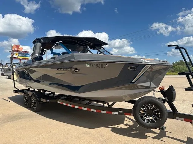 Slide: The Image of A gray boat on a trailer, ready for transport. The sky is clear and sunny. - 7