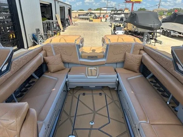Slide: The Image of The image shows the luxurious interior of a Nautique Super Air Nautique G25 Paragon boat with beige leather seating. - 30