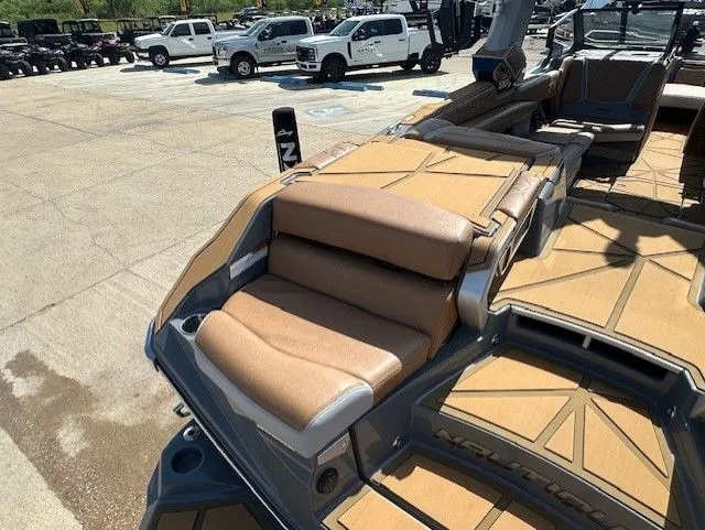 Slide: The Image of The image shows the deck of a 2025 Nautique Super Air Nautique G25 Paragon with luxurious seating. - 11