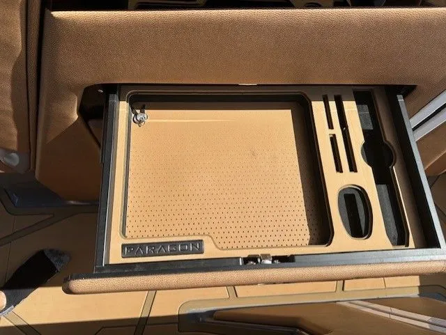 Slide: The Image of A sleek, well-organized storage compartment with Paragon logo, surrounded by brown upholstery. - 28