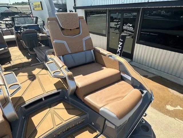 Slide: The Image of The image shows the luxurious cockpit of a 2025 Super Air Nautique G25 Paragon with brown upholstery. - 13