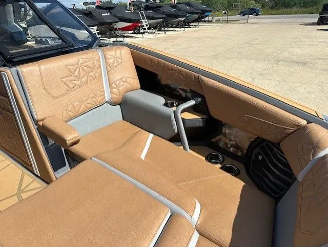 Slide: The Image of Interior of a Nautique Super Air Nautique G25 Paragon with beige upholstery and cup holders. - 33
