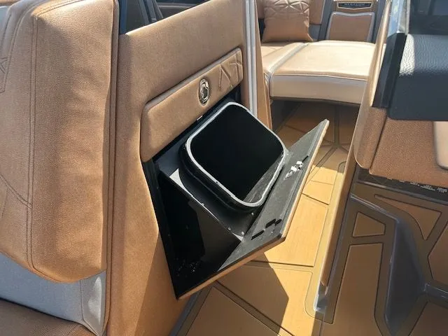 Slide: The Image of Interior of the 2025 Nautique Super Air Nautique G25 Paragon with a built-in trash bin. - 29