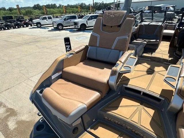 Slide: The Image of Luxurious lounge seating on a 2025 Nautique Super Air Nautique G25 Paragon, surrounded by other boats. - 14