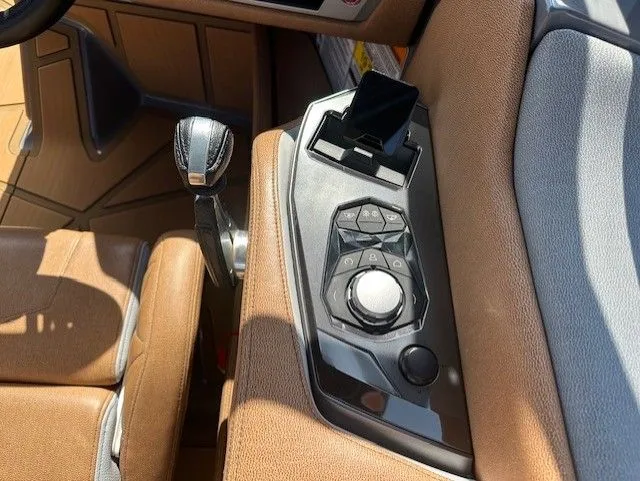 Slide: The Image of Interior view of a Nautique Super Air Nautique G25 Paragon with brown seats and control console. - 26