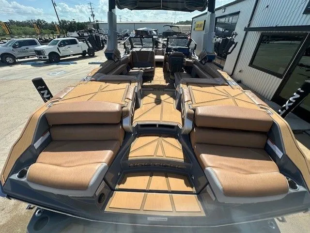 Slide: The Image of The image shows the spacious deck of a Nautique Super Air Nautique G25 Paragon with luxurious seating. - 10