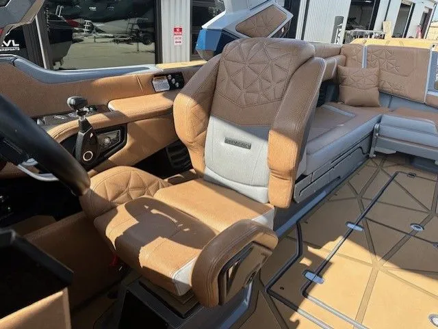 Slide: The Image of Interior of a luxury boat with brown and gray upholstered seats and modern controls. - 24
