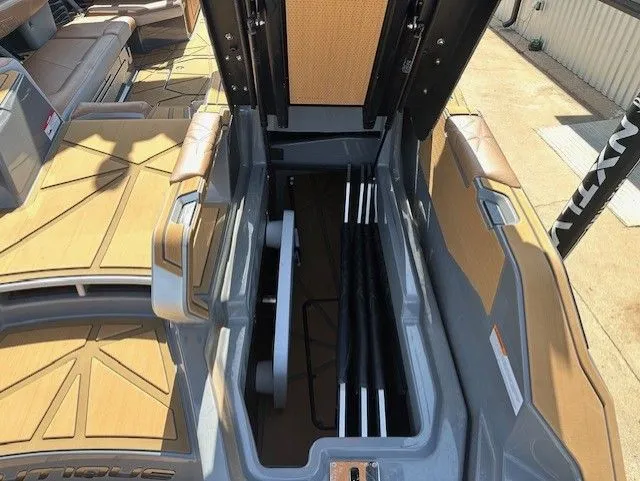 Slide: The Image of The image shows the storage compartment of a 2025 Nautique Super Air Nautique G25 Paragon boat. - 17