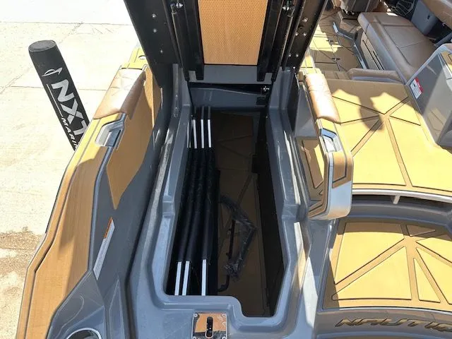 Slide: The Image of Boat storage compartment with open lid, showing interior and poles. - 16