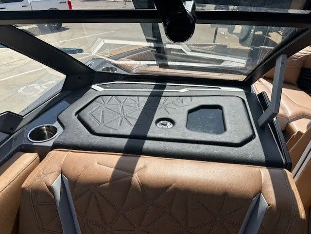 Slide: The Image of Interior of a Nautique Super Air Nautique G25 Paragon with brown leather seats and a black dashboard. - 22