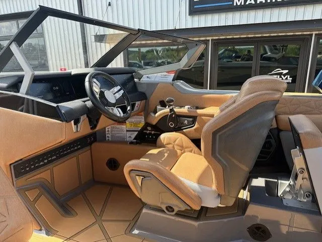 Slide: The Image of The image shows the cockpit of a 2025 Nautique Super Air Nautique G25 Paragon with luxurious seating. - 23