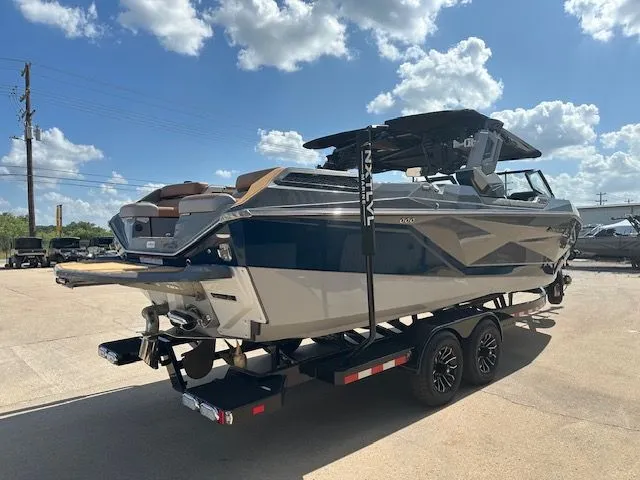 Slide: The Image of A 2025 Super Air Nautique G25 Paragon on a trailer under a blue sky. - 5