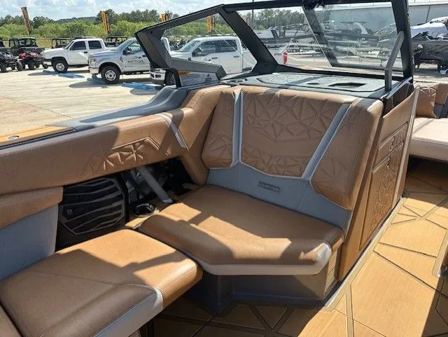 Slide: The Image of Interior of a 2025 Nautique Super Air Nautique G25 Paragon with brown upholstery. - 21