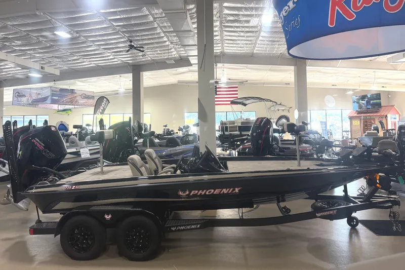 The Image of 2027 Phoenix 721 ZXL boat displayed in a showroom with other marine equipment. - 0