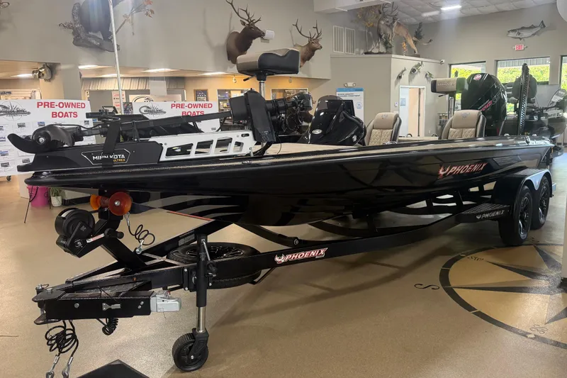 Slide: The Image of 2027 Phoenix 721 ZXL boat displayed indoors, surrounded by pre-owned boat signs. - 3