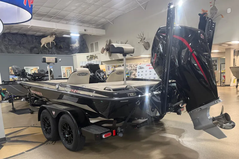 Slide: The Image of 2027 Phoenix 721 ZXL bass boat displayed indoors with powerful outboard motor. - 4