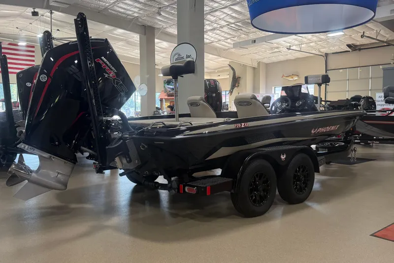 Slide: The Image of 2027 Phoenix 721 ZXL boat displayed indoors with powerful outboard motor. - 2